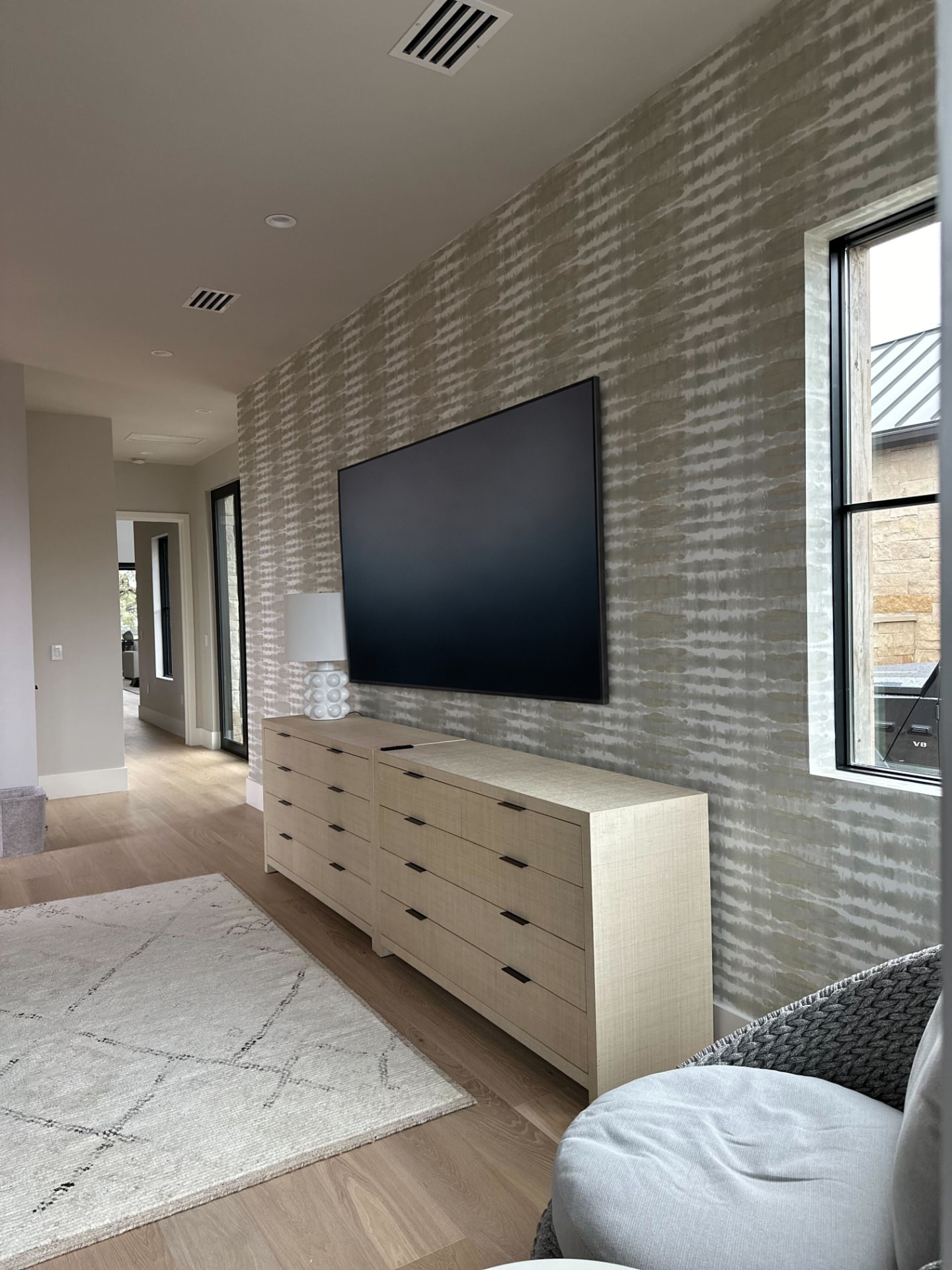 Bedroom suite with an integrated television above the dressers
