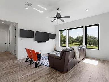 Media room with wall-mounted screens and integrated seating