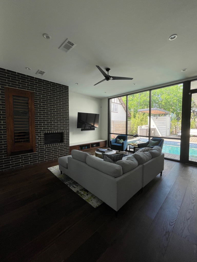 Finished living room with a discreet motion sensor mounted high on the wall