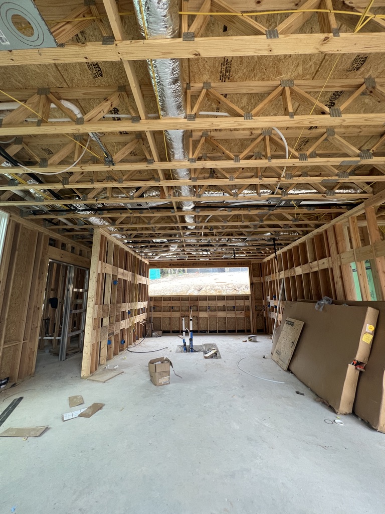 Interior framing, ductwork, and rough-in wiring in a home under construction