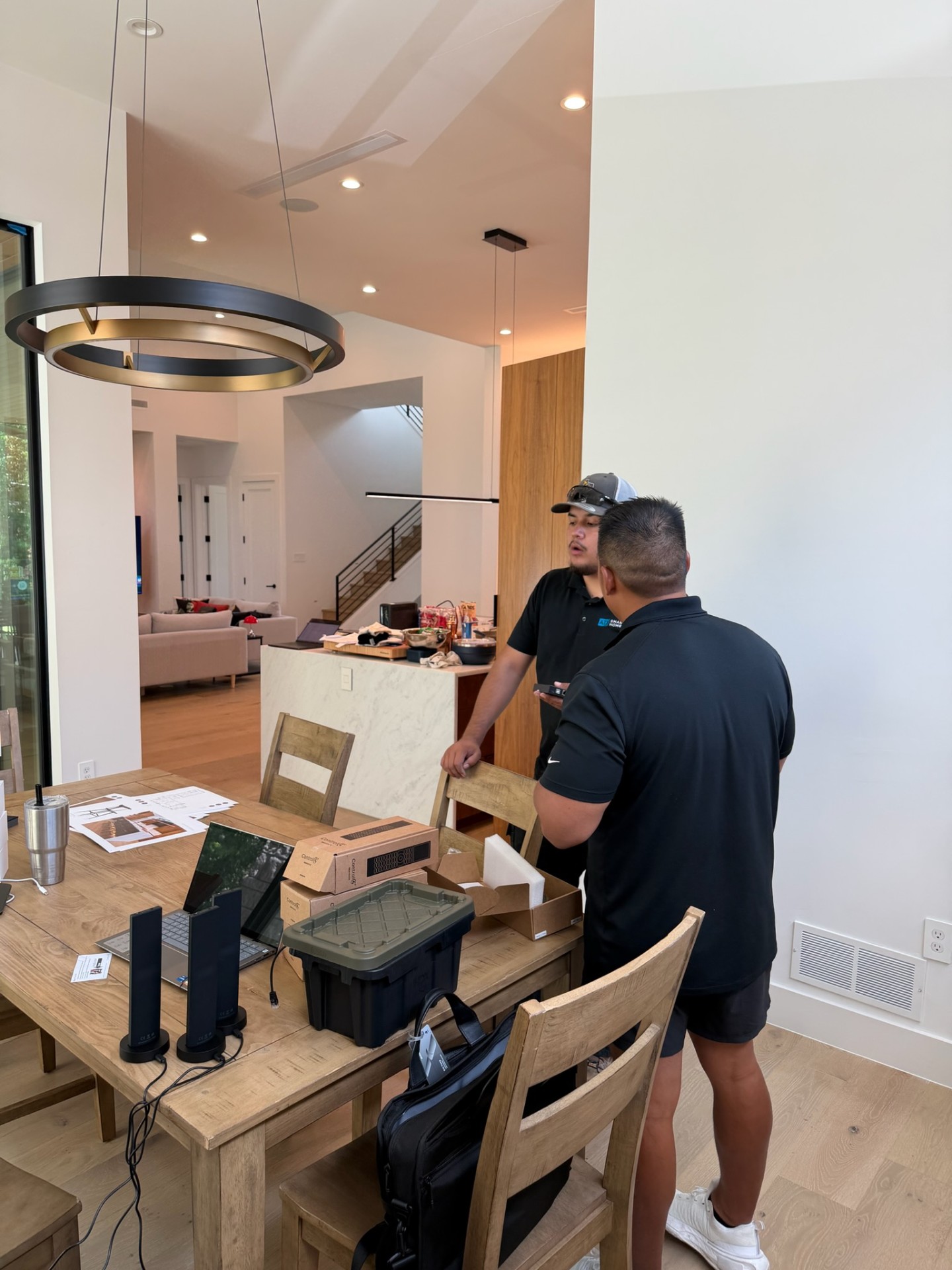 ATX Smart Homes team setting up and testing audio equipment and programming before an installation