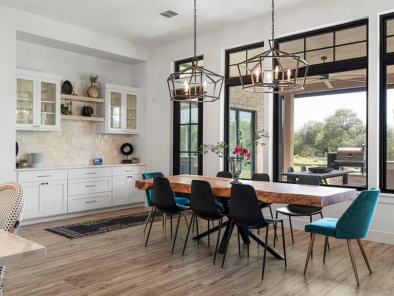 Dining room with automated shades and coordinated lighting