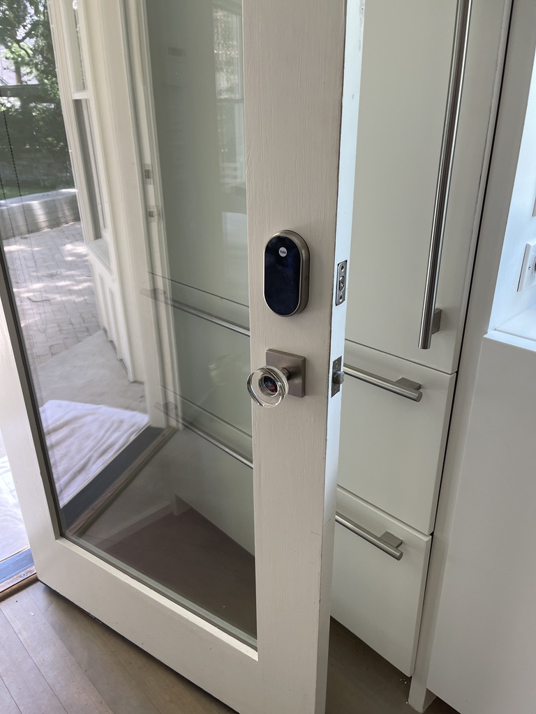 Smart lock fitted to a glazed interior door opening onto a patio